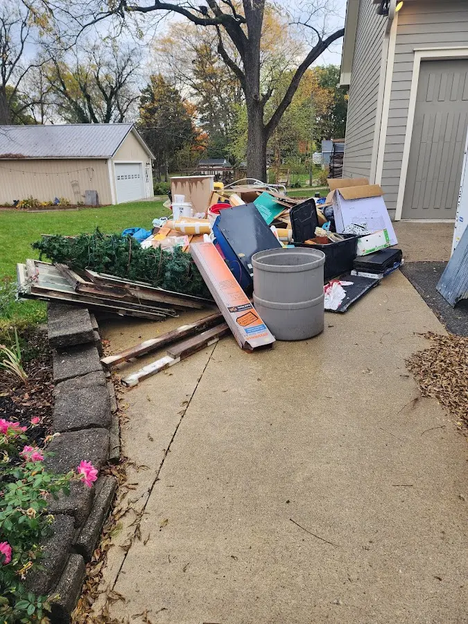 Dumpster being loaded with debris for Commercial Dumpster Rental in Romeo